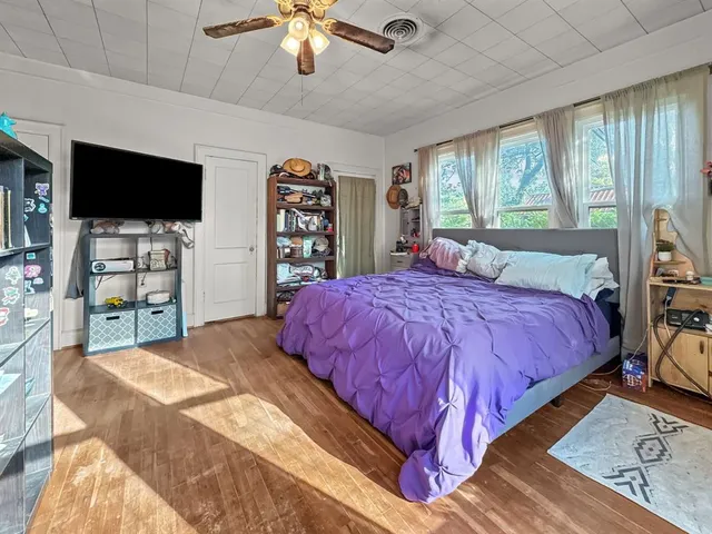 a bedroom with a bed and a flat screen tv