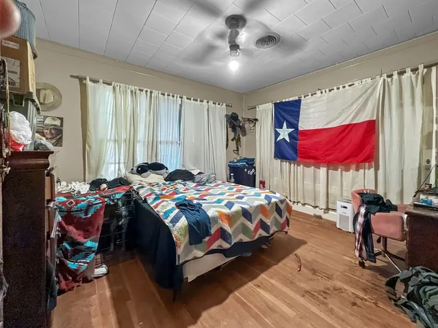 a bedroom that has a bed and a chair