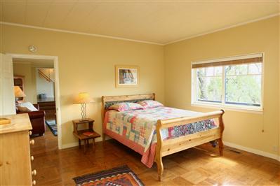 11 Crest Road Ross, CA 94960 - Photo 8 of 11 a bedroom with a bed and wooden floor