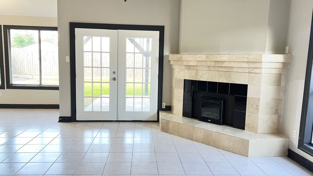 5606 Lyden Ridge Drive Houston, TX 77053 - Photo 11 of 34 an empty room with windows and fireplace