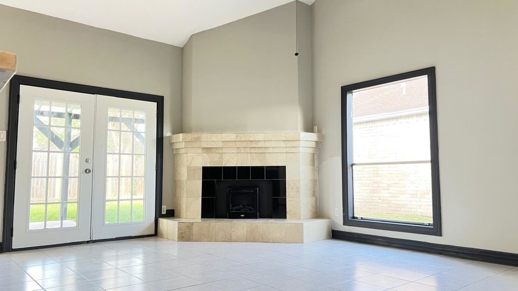 5606 Lyden Ridge Drive Houston, TX 77053 - Photo 26 of 34 a view of an empty room with a fireplace and a window