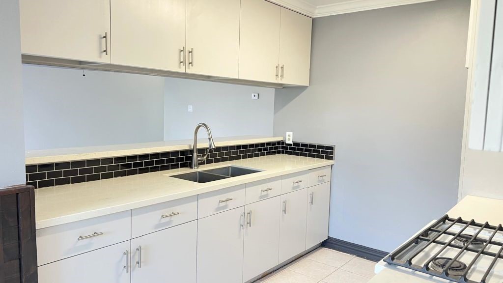 5606 Lyden Ridge Drive Houston, TX 77053 - Photo 5 of 34 a kitchen with granite countertop white cabinets and a stove
