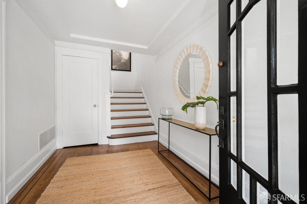 184 Santa Rosa Avenue San Francisco, CA 94112 - Photo 4 of 46 a view of a hallway with wooden floor and staircase