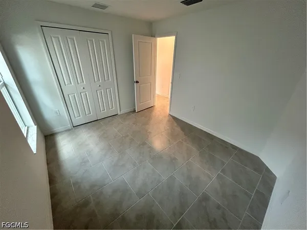 a view of an empty room with windows