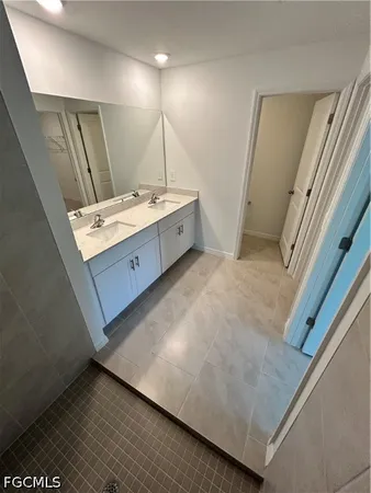 a bathroom with a sink and mirror