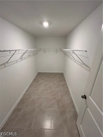 a view of storage and utility room with racks on the wall