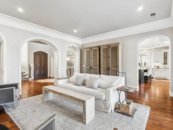 a living room with furniture a large window and a flat screen tv