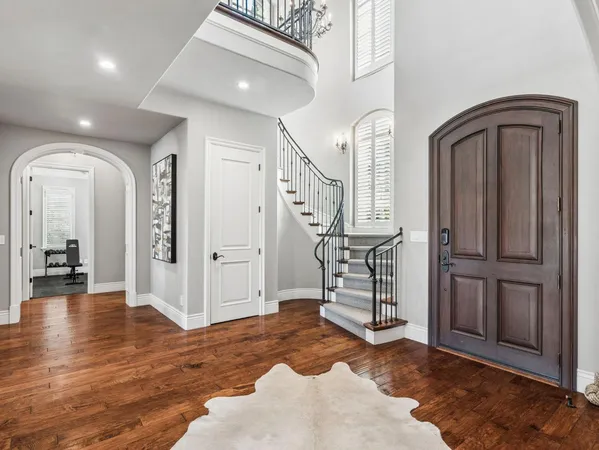 a kitchen with stainless steel appliances granite countertop a kitchen island a stove and a wooden floors