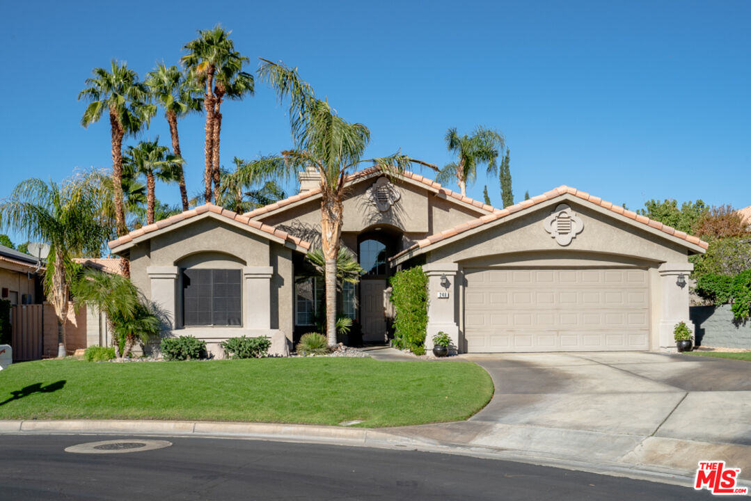248 Corte Sole Palm Desert, CA 92260 - Photo 2 of 29 a front view of a house with a garden and plants