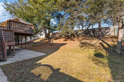 a view of a patio with a table and chairs