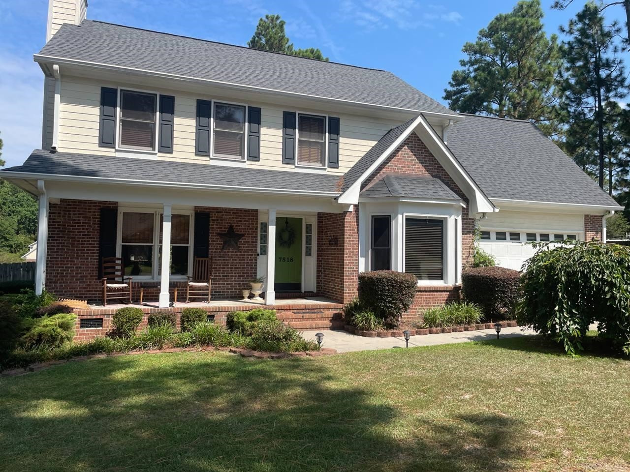 7818 Shuttle Road Fayetteville, NC 28311 - Photo 1 of 21 a front view of a house with a garden and porch