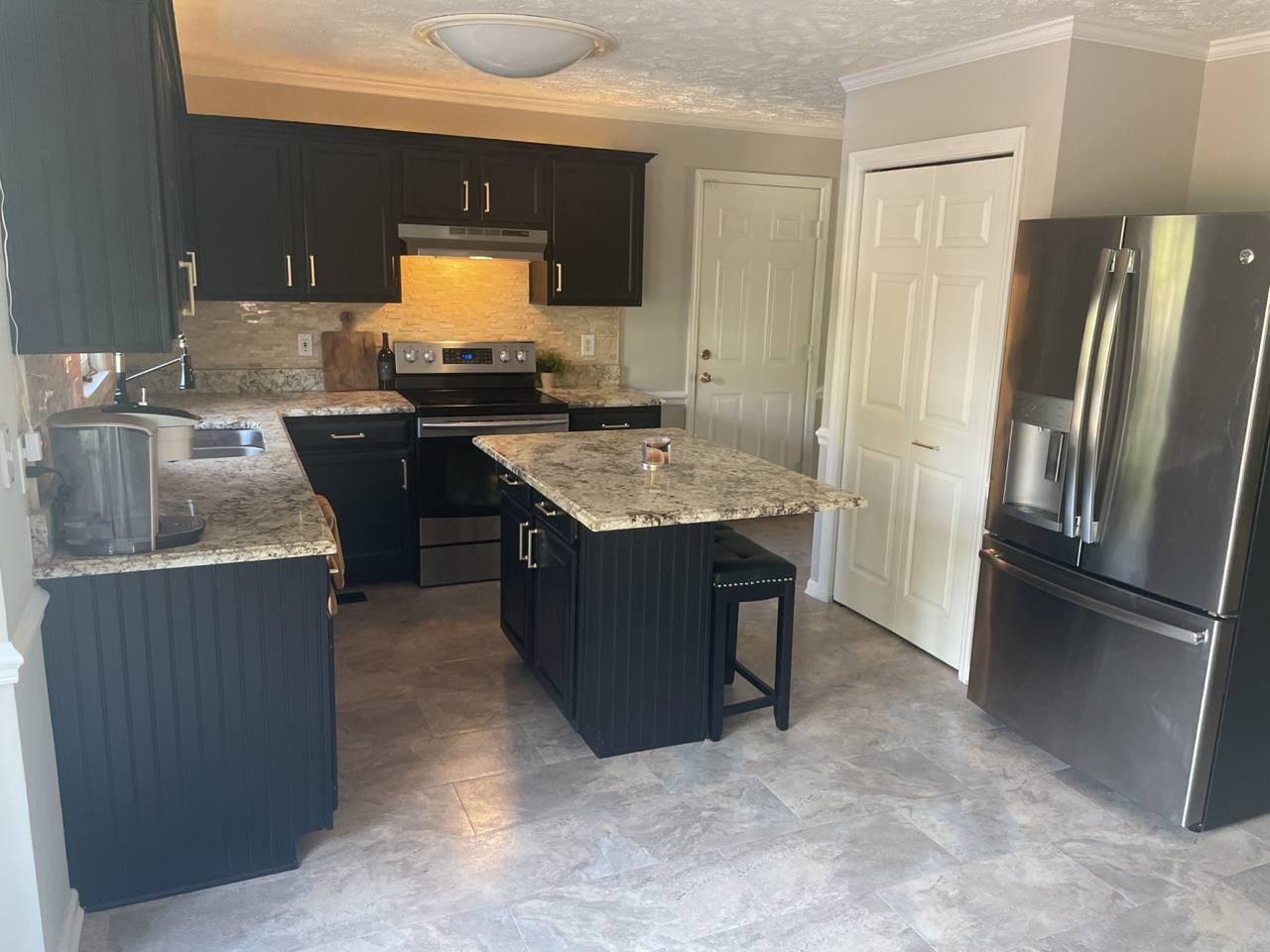 7818 Shuttle Road Fayetteville, NC 28311 - Photo 6 of 21 a kitchen with granite countertop a refrigerator and a stove
