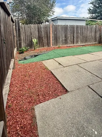 a view of a house with wooden fence