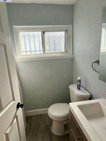 a white toilet sitting next to a bathroom sink