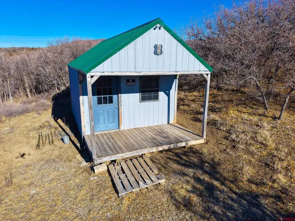 a view of a dry field with mountains in the background