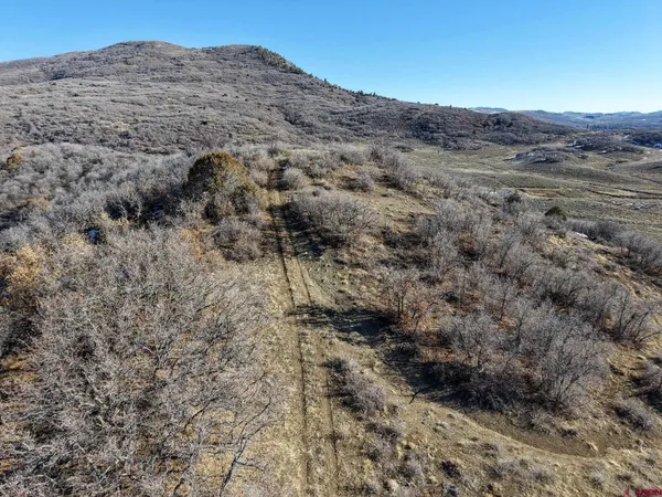 a backyard of a house with barbeque oven table and chairs