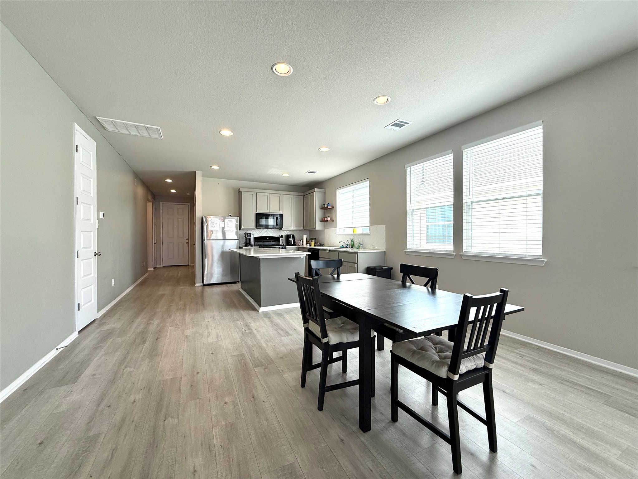 133 Fabion Street Kyle, TX 78640 - Photo 5 of 17 a view of a dining room with furniture and wooden floor