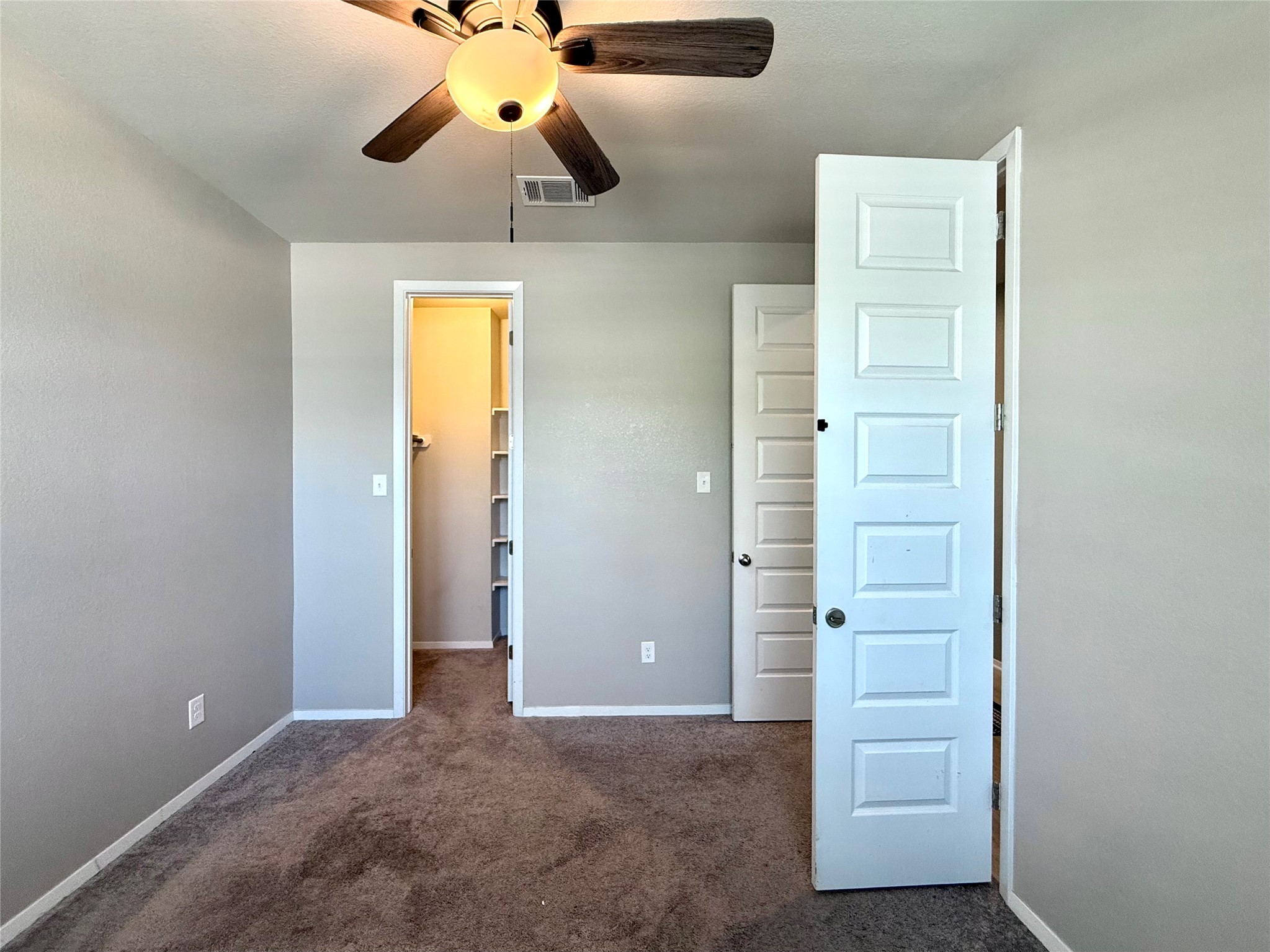 133 Fabion Street Kyle, TX 78640 - Photo 9 of 17 an empty room with closet and a chandelier fan