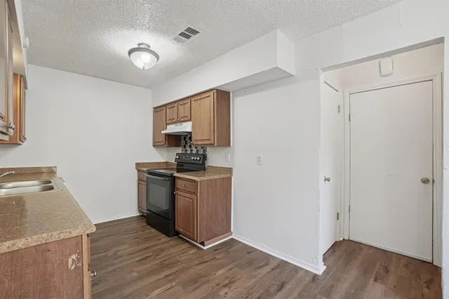 a kitchen with a refrigerator and a stove