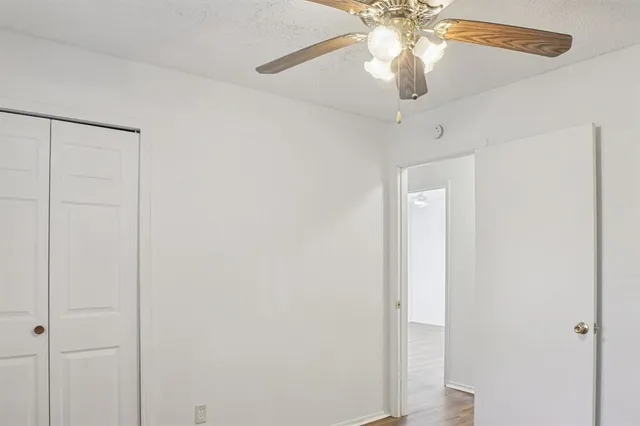 a view of a chandelier fan and closet in a room
