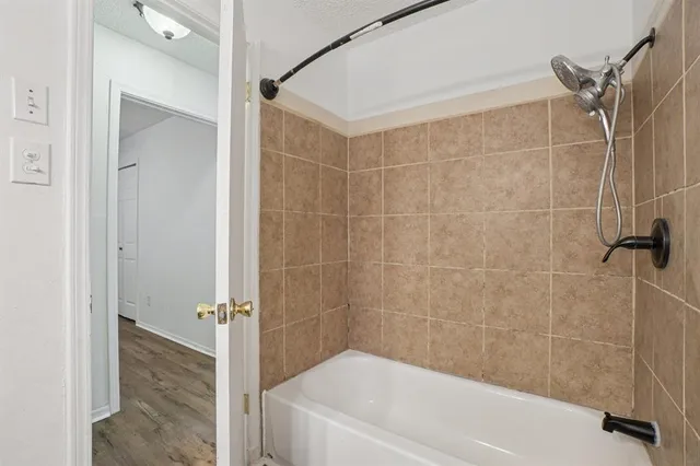 a bathroom with a bathtub and shower