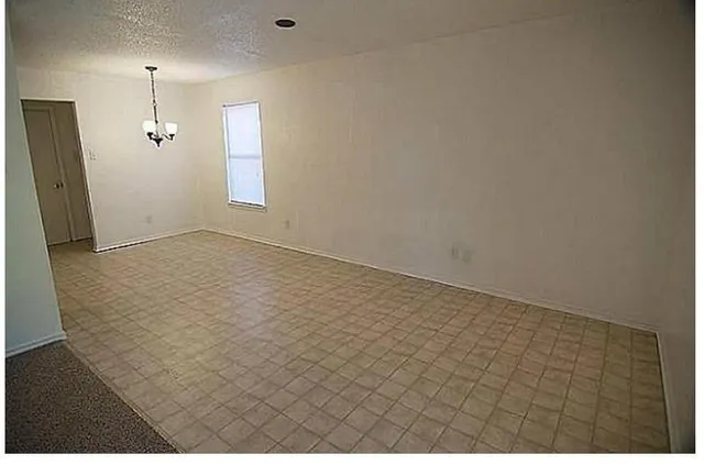 en empty room with wooden floor
