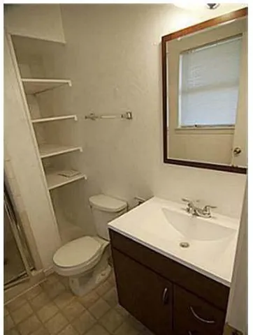 a bathroom with a sink a toilet and mirror