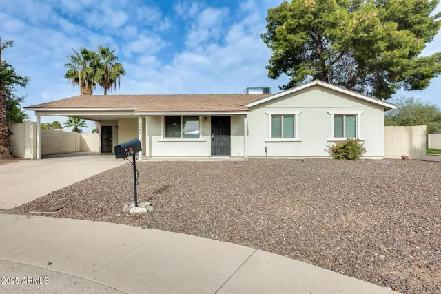 a front view of a house with a yard and a garage
