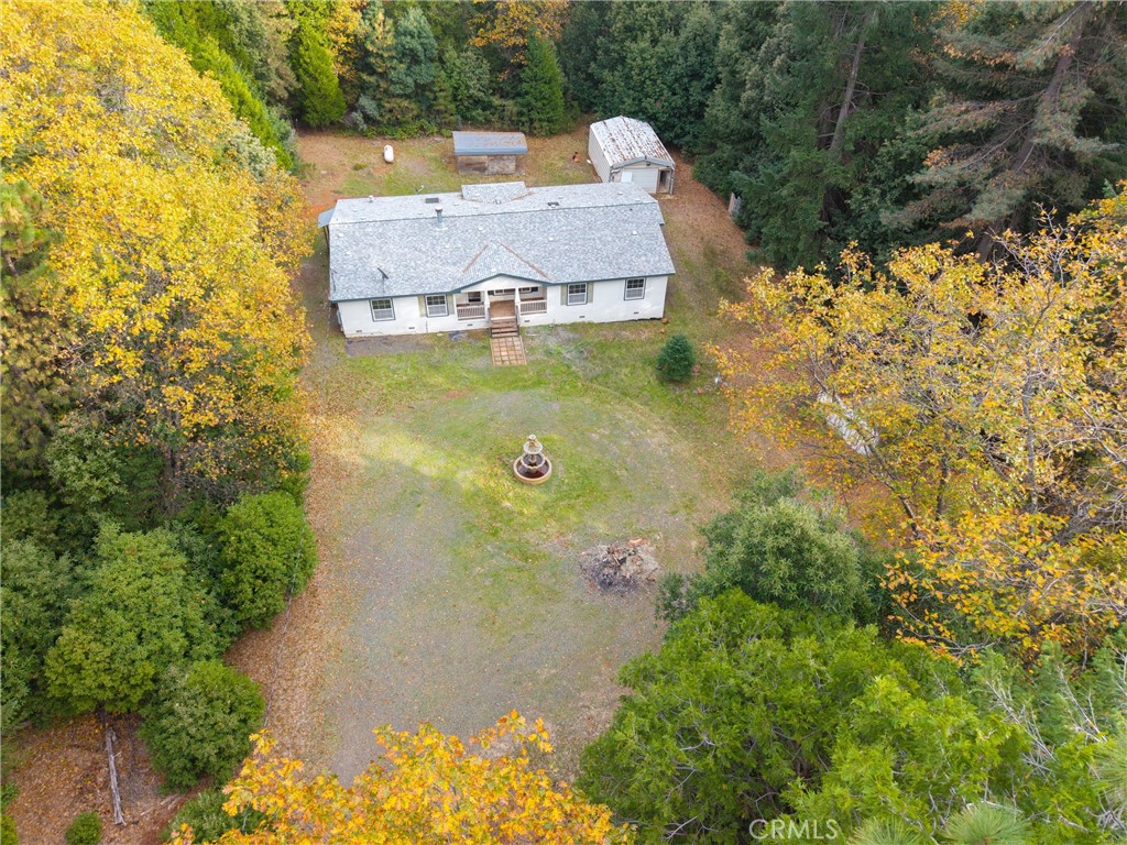 an aerial view of a house with a yard and lake view