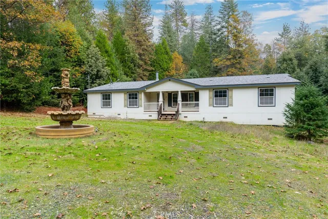 a front view of a house with a yard patio and fire pit