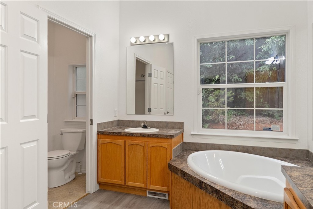 17 Weiss Hill Road Oroville, CA 95966 - Photo 24 of 35 a spacious bathroom with a granite countertop tub a sink and a large window