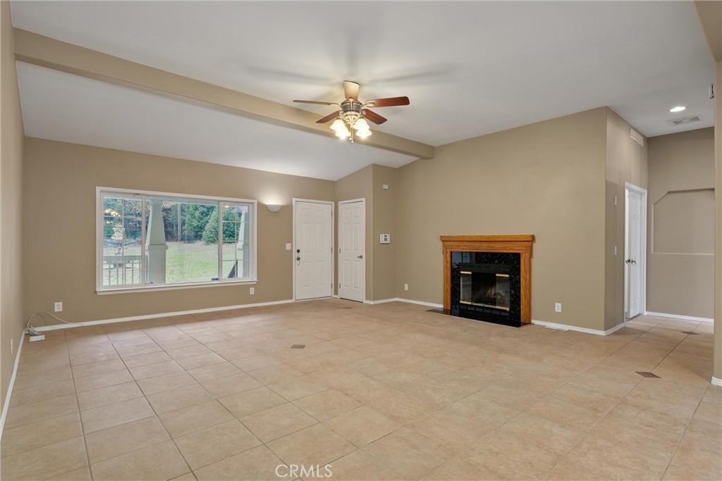 17 Weiss Hill Road Oroville, CA 95966 - Photo 3 of 35 an empty room with windows and ceiling fan