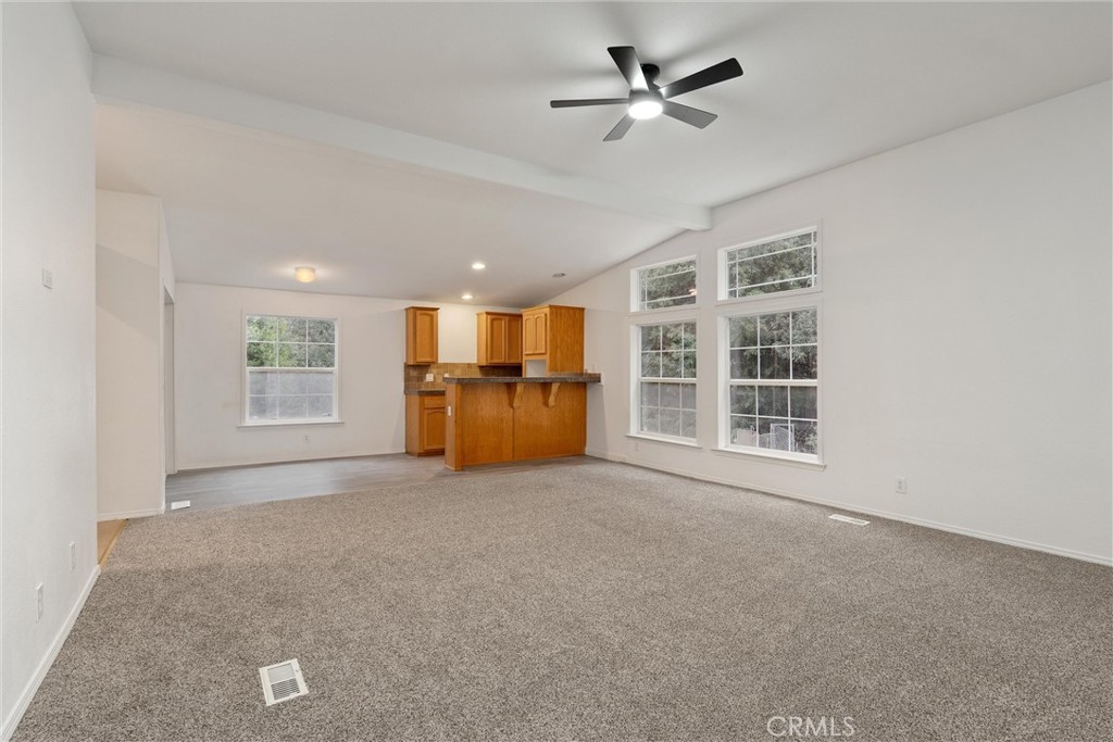 17 Weiss Hill Road Oroville, CA 95966 - Photo 6 of 35 a view of an empty room with a window and kitchen view
