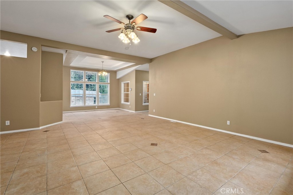 17 Weiss Hill Road Oroville, CA 95966 - Photo 8 of 35 an empty room with windows and chandelier fan