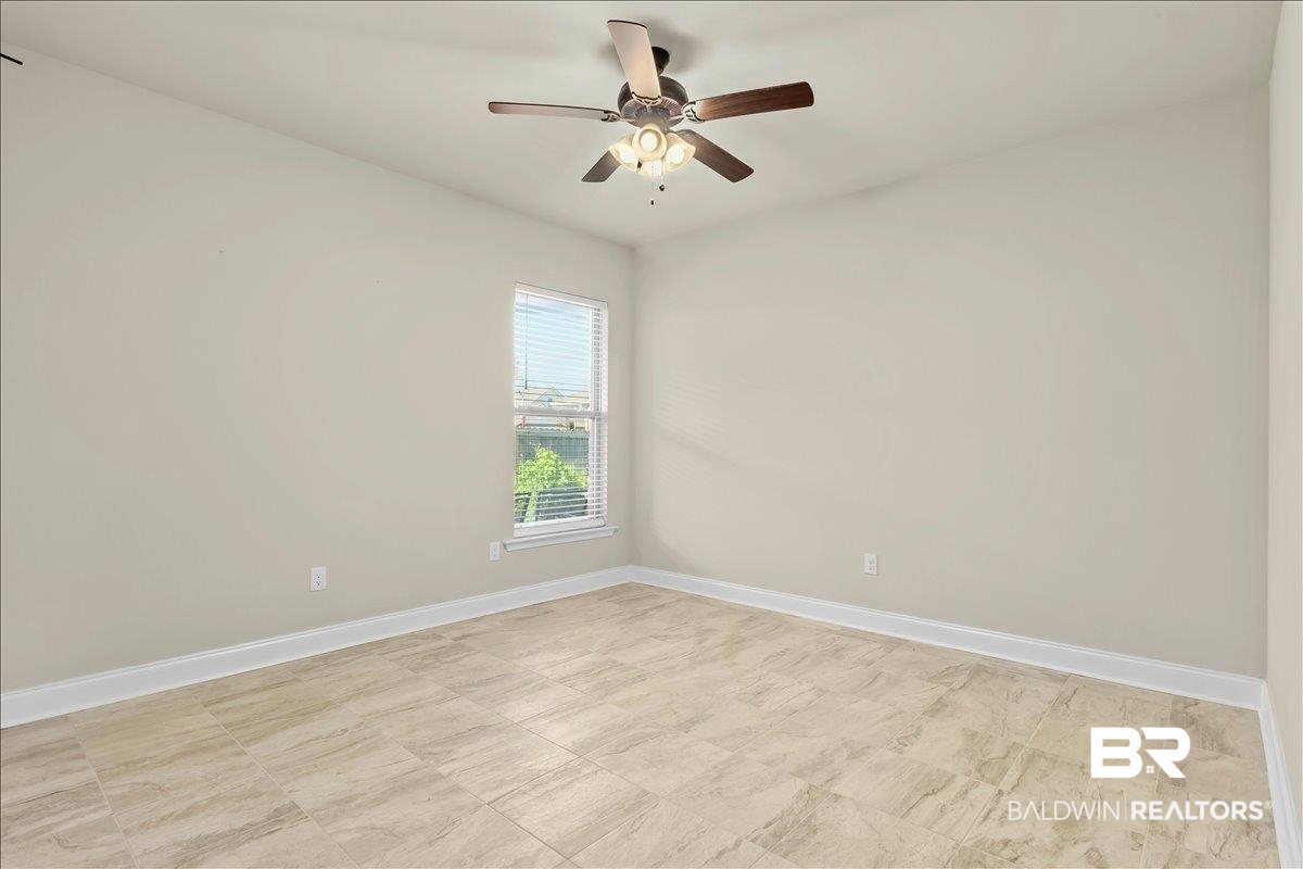 1112 Stella Road Foley, AL 36535 - Photo 16 of 33 Unfurnished room with baseboards and ceiling fan