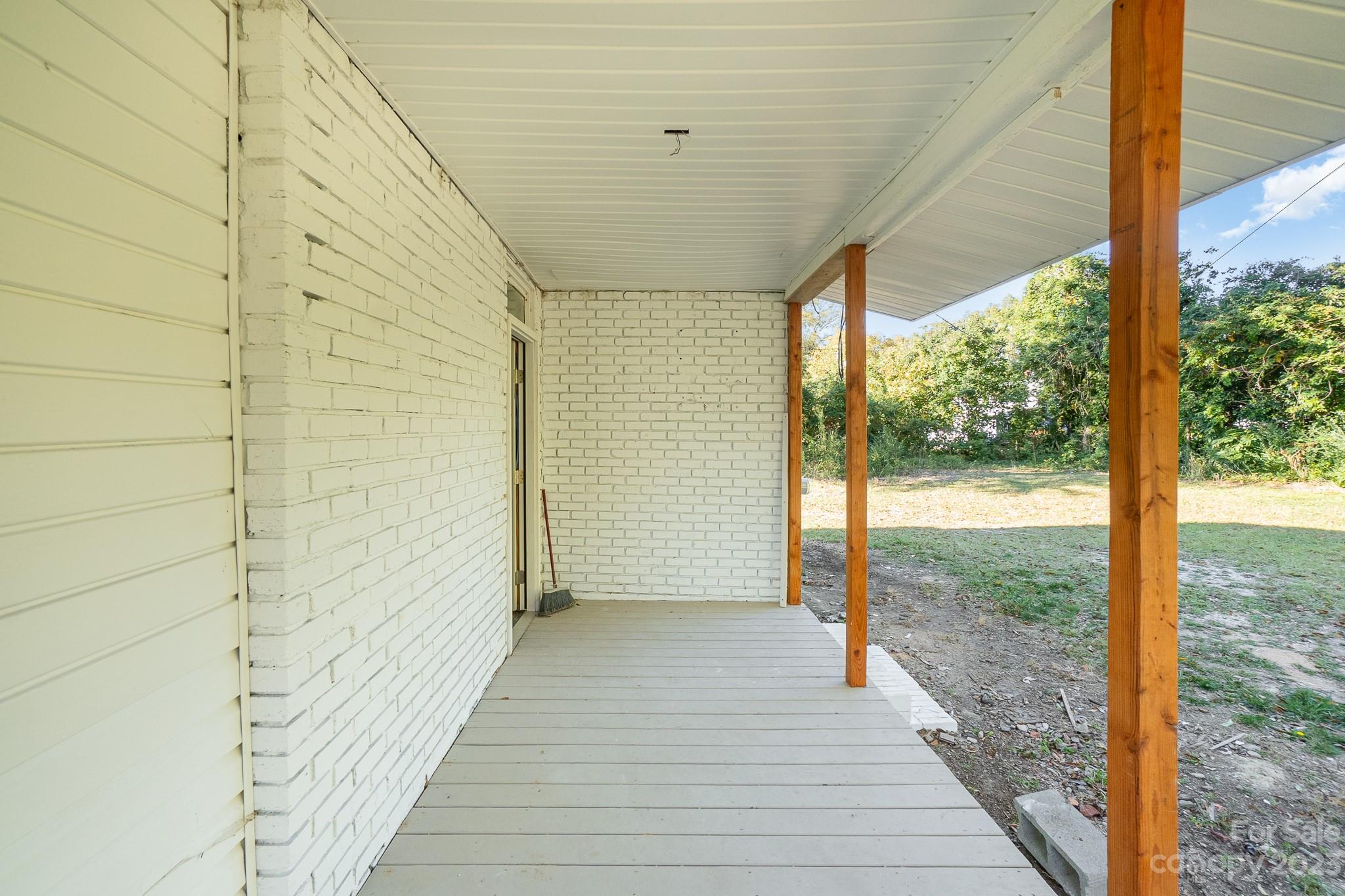 113 Brawley Street Chester, SC 29706 - Photo 15 of 29 a view of a room with wooden floor and iron stairs
