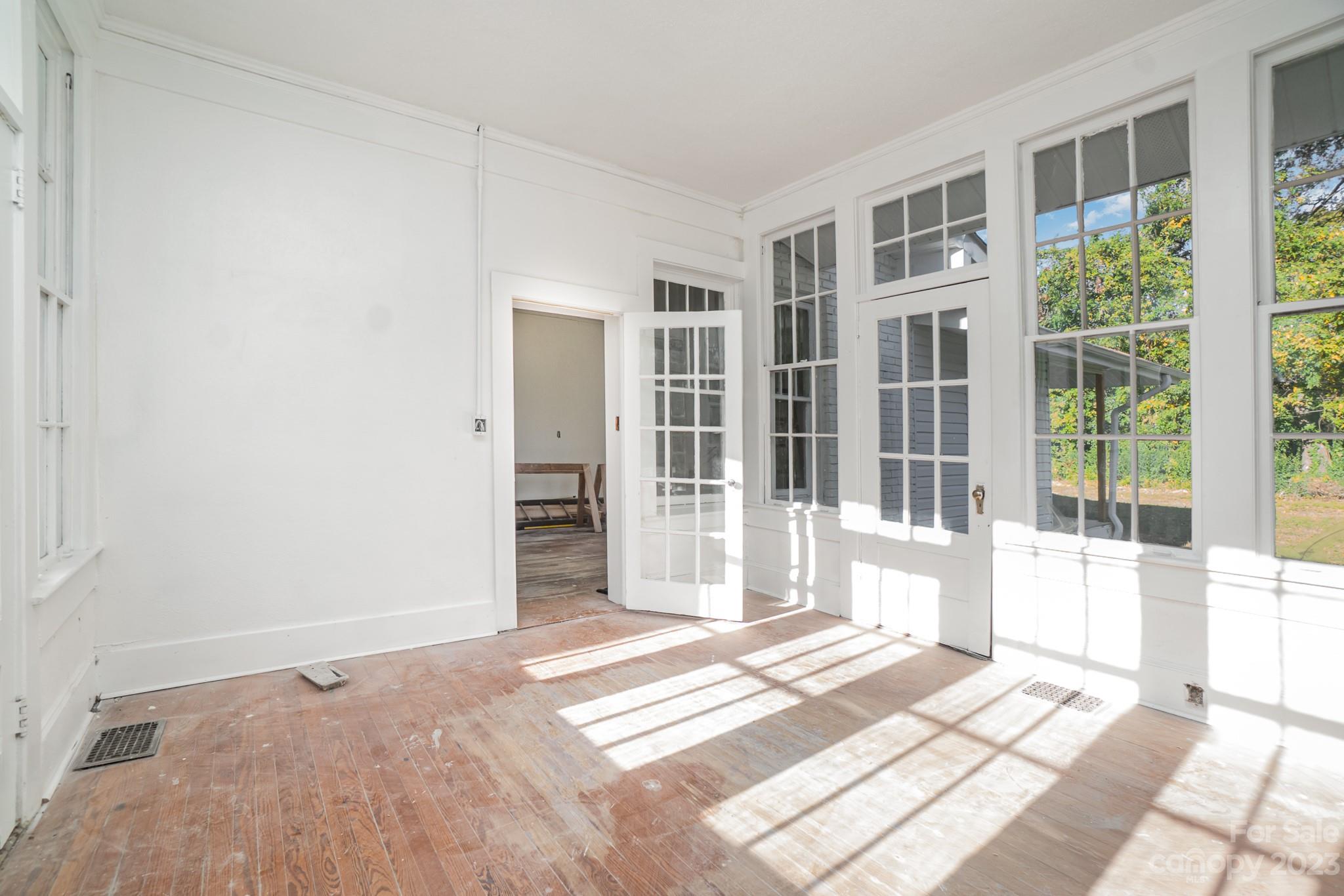 113 Brawley Street Chester, SC 29706 - Photo 6 of 29 a view of a bedroom with wooden floor and windows