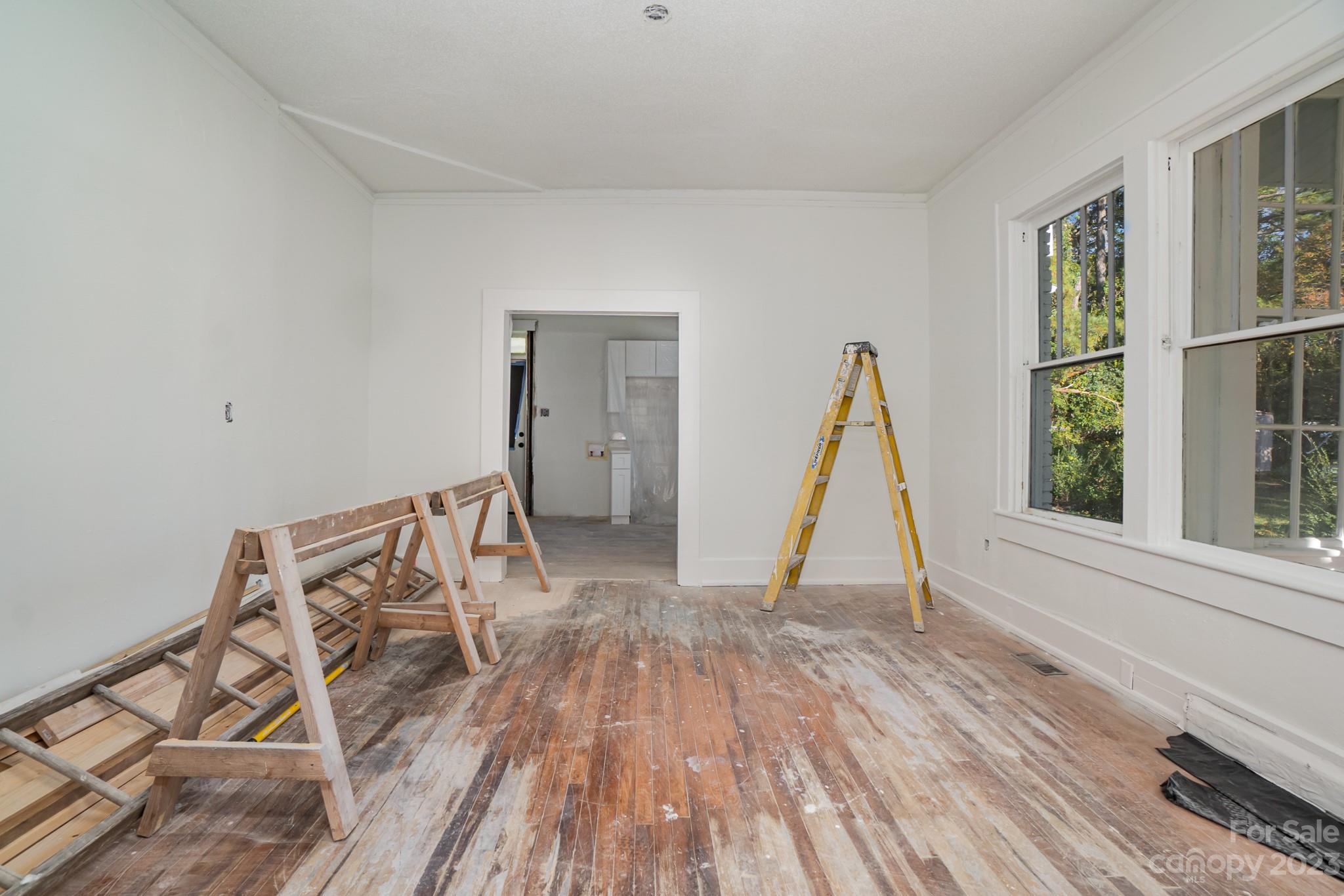 113 Brawley Street Chester, SC 29706 - Photo 7 of 29 a view of a room with wooden floor and windows