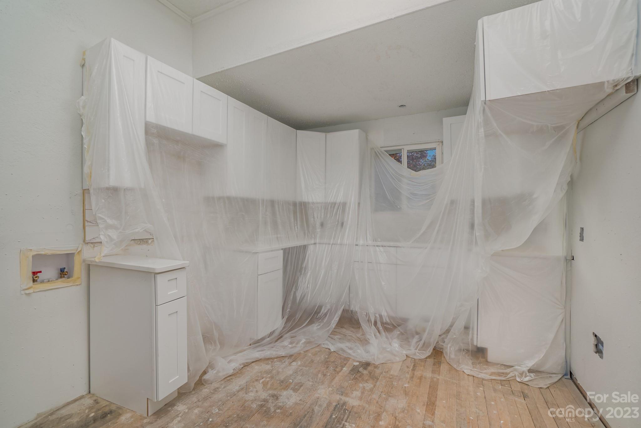 113 Brawley Street Chester, SC 29706 - Photo 10 of 29 a view of a room with wooden floor and cabinet
