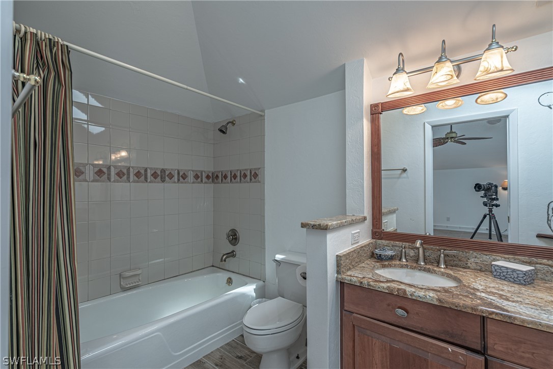 124 Useppa Island Bokeelia, FL 33922 - Photo 17 of 30 a bathroom with a granite countertop sink a toilet and shower