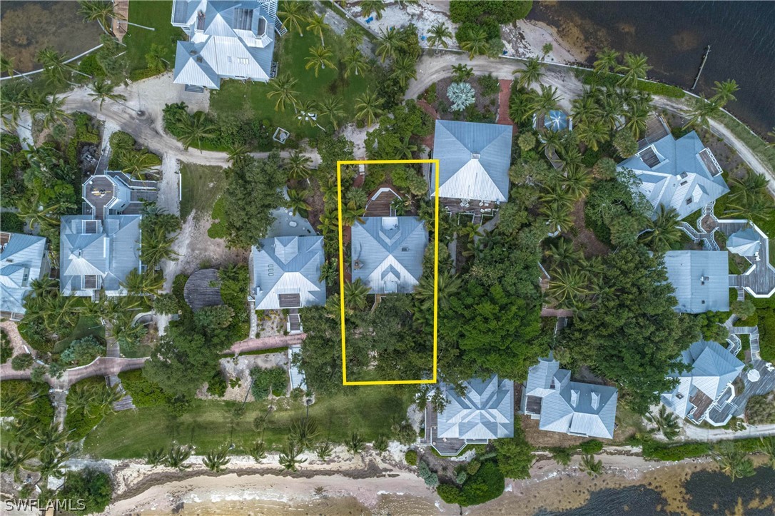 124 Useppa Island Bokeelia, FL 33922 - Photo 30 of 30 an aerial view of a house with a yard and a large tree
