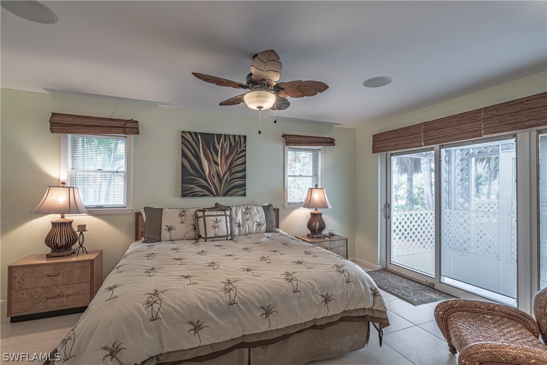124 Useppa Island Bokeelia, FL 33922 - Photo 10 of 30 a bedroom with a large bed and a chandelier fan