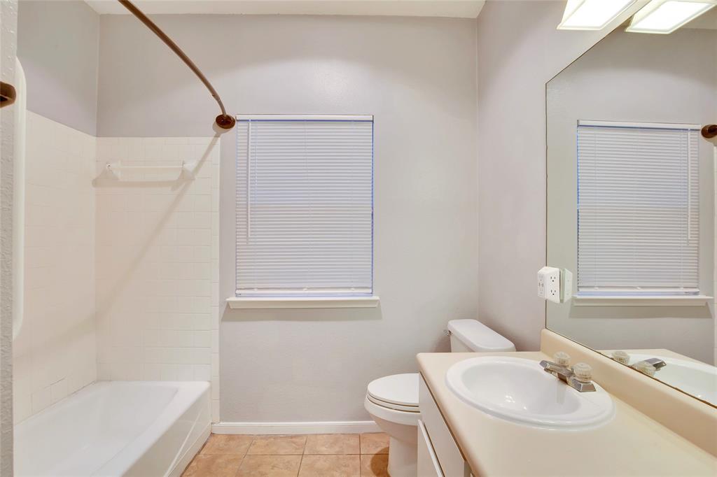 3113 Robinson Avenue, Unit B Austin, TX 78722 - Photo 14 of 16 a bathroom with a sink a toilet and shower