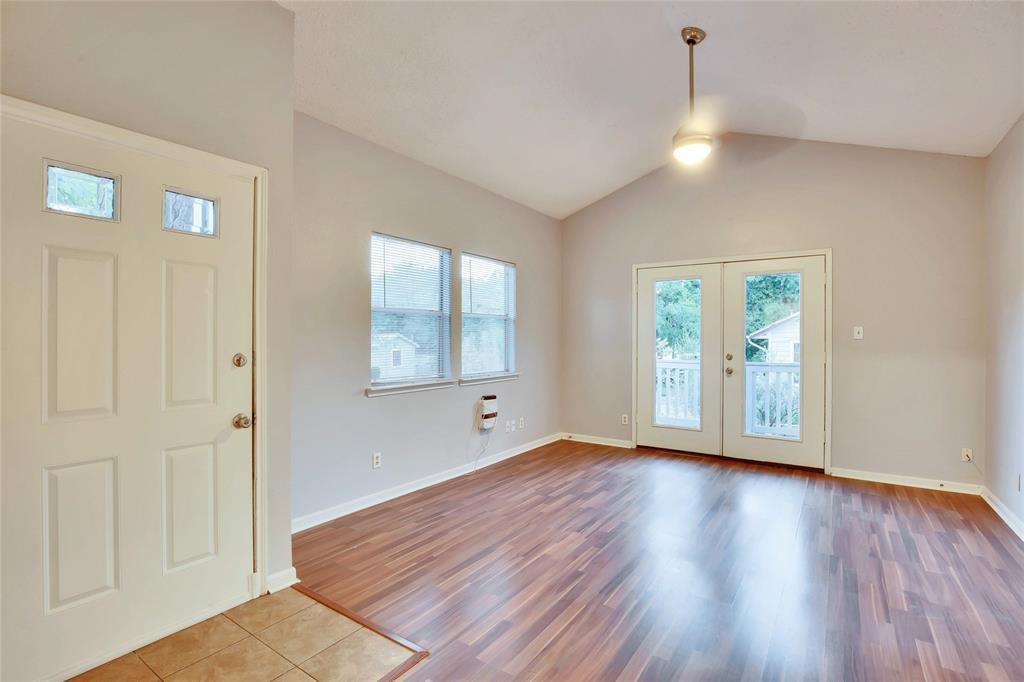 3113 Robinson Avenue, Unit B Austin, TX 78722 - Photo 2 of 16 an empty room with wooden floor and windows