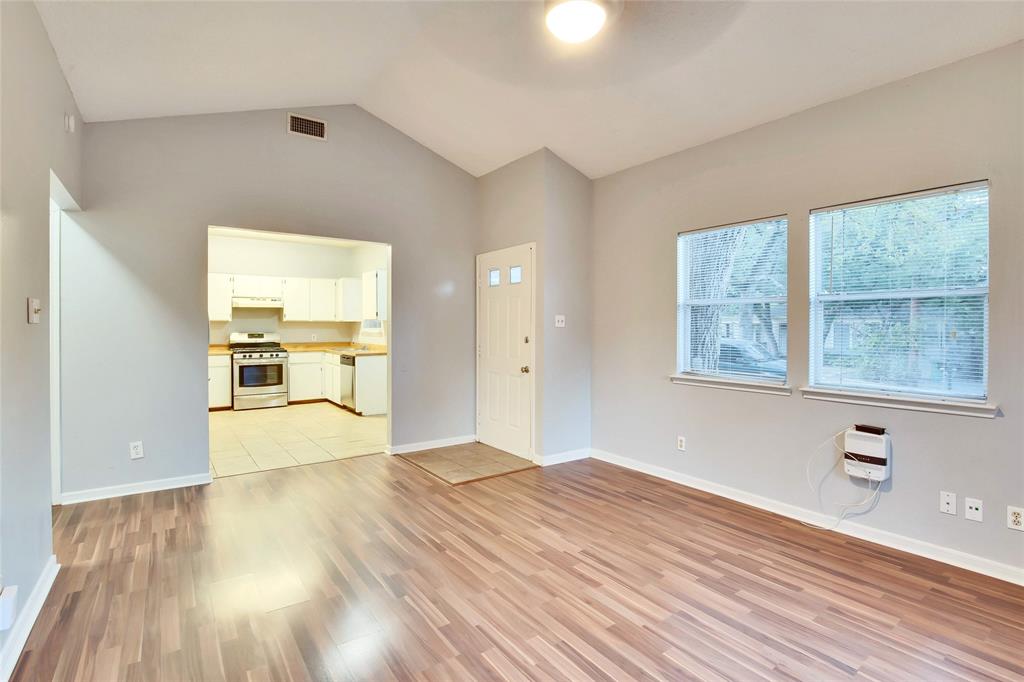 3113 Robinson Avenue, Unit B Austin, TX 78722 - Photo 3 of 16 a view of a kitchen with wooden floor and a window