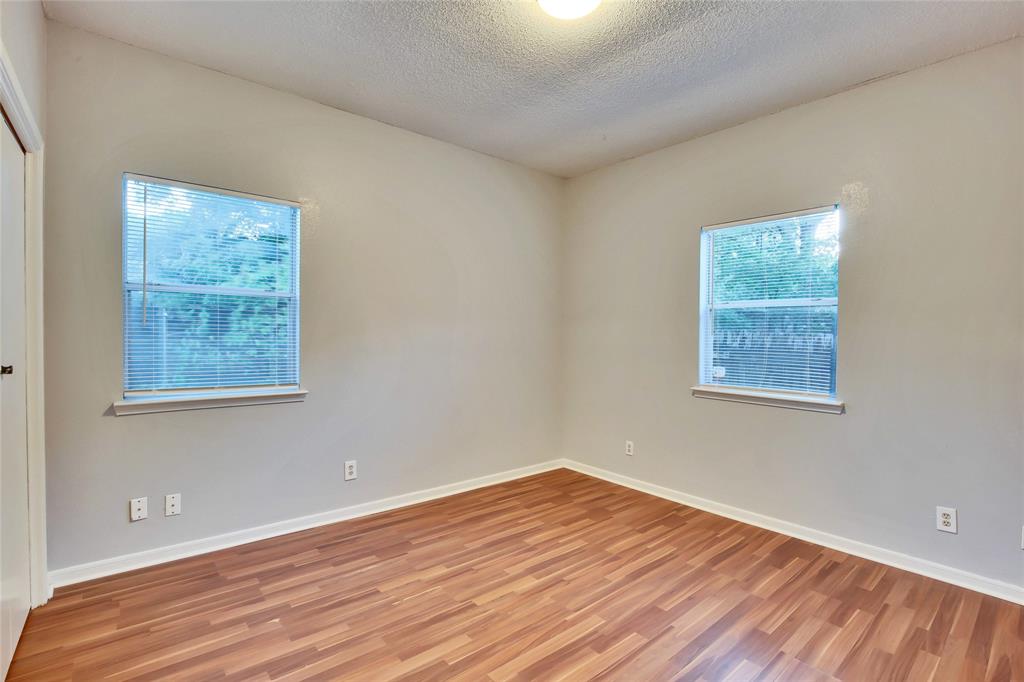 3113 Robinson Avenue, Unit B Austin, TX 78722 - Photo 8 of 16 a view of an empty room with wooden floor and a window