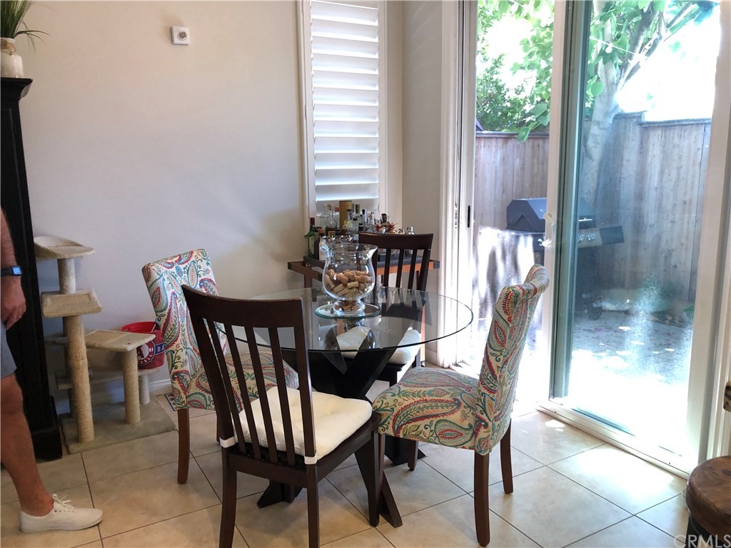 303 Canoe Pond Costa Mesa, CA 92627 - Photo 11 of 49 a view of a dining room with furniture and window