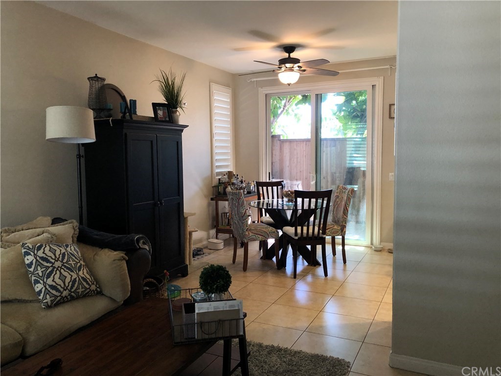 303 Canoe Pond Costa Mesa, CA 92627 - Photo 12 of 49 a dining room with furniture a chandelier and window