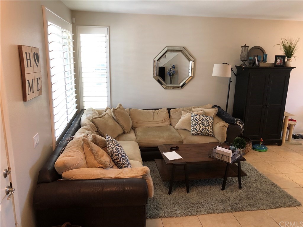 303 Canoe Pond Costa Mesa, CA 92627 - Photo 13 of 49 a living room with furniture and a mirror