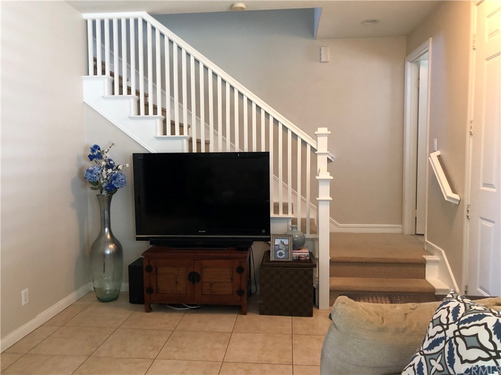 303 Canoe Pond Costa Mesa, CA 92627 - Photo 15 of 49 a living room with furniture and a flat screen tv